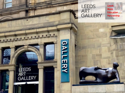 The front of Leeds Art Gallery with a sculpture of a woman lying on her side in the foreground