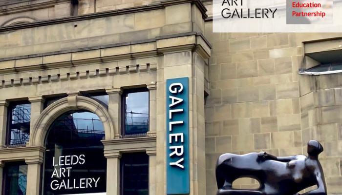 The front of Leeds Art Gallery with a sculpture of a woman lying on her side in the foreground