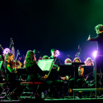 City of Leeds Youth Orchestra playing on the Leeds arena stage.