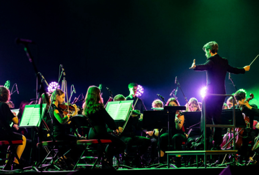 City of Leeds Youth Orchestra playing on the Leeds arena stage.