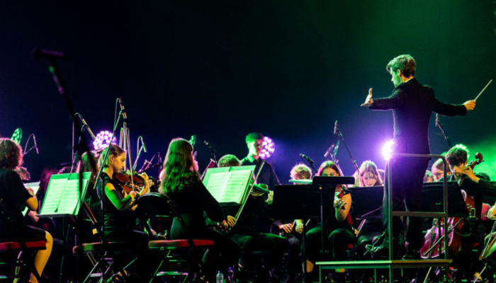City of Leeds Youth Orchestra playing on the Leeds arena stage.
